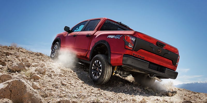 2024 Nissan Titan image of red truck driving up a rocky hill