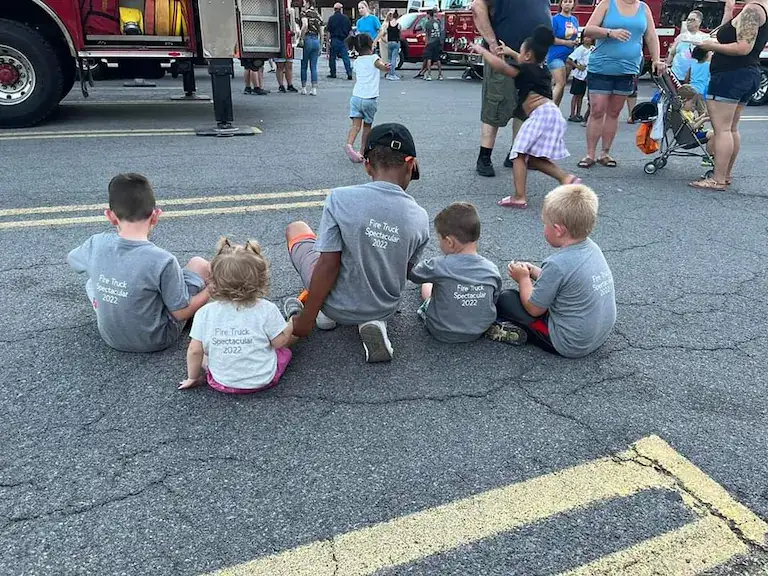 Children sitting together on a street